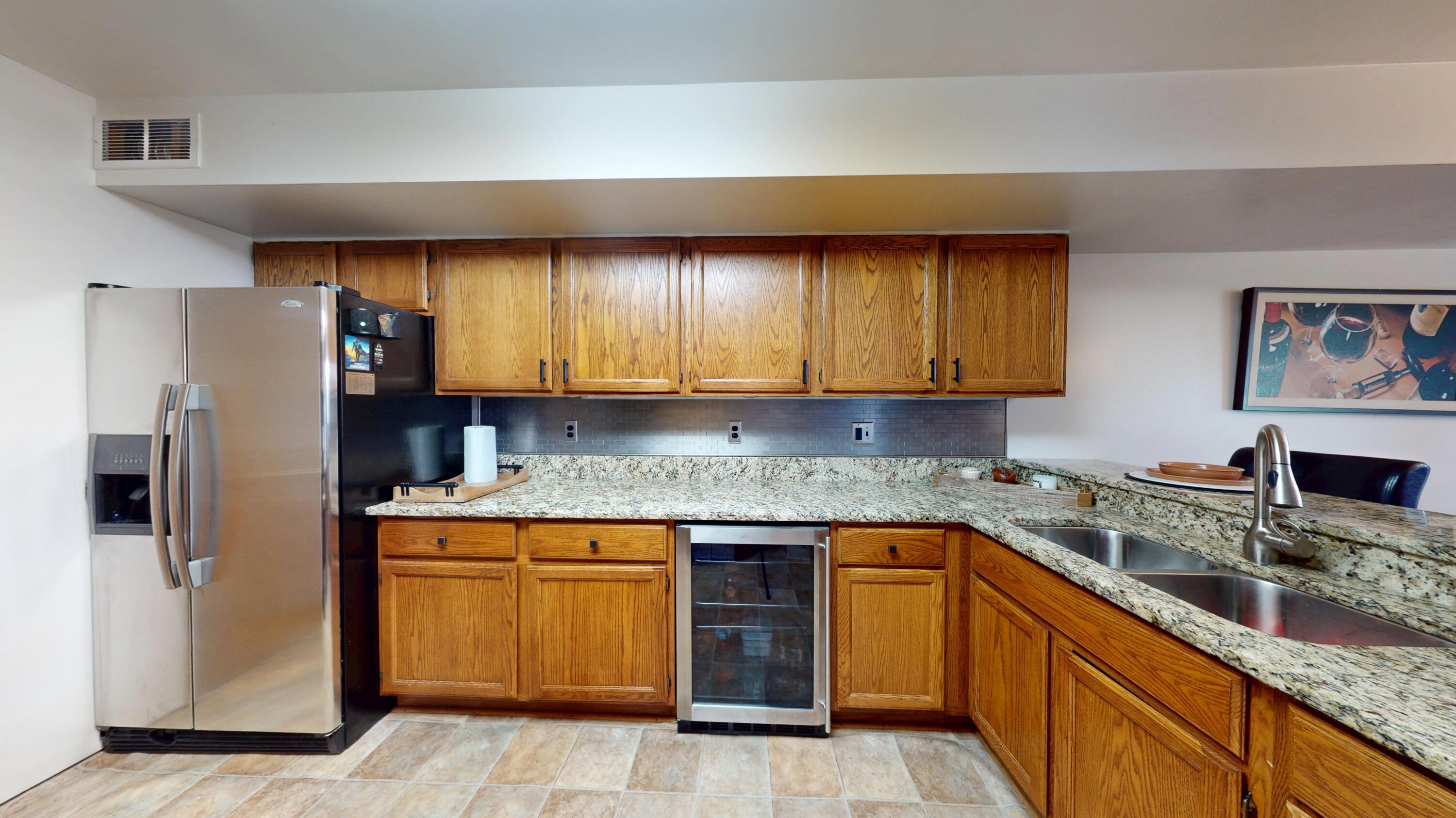 9344 Van Buren Street Crown Point, IN 46307 - Photo 14 of 37 a kitchen with stainless steel appliances granite countertop a sink stove and refrigerator