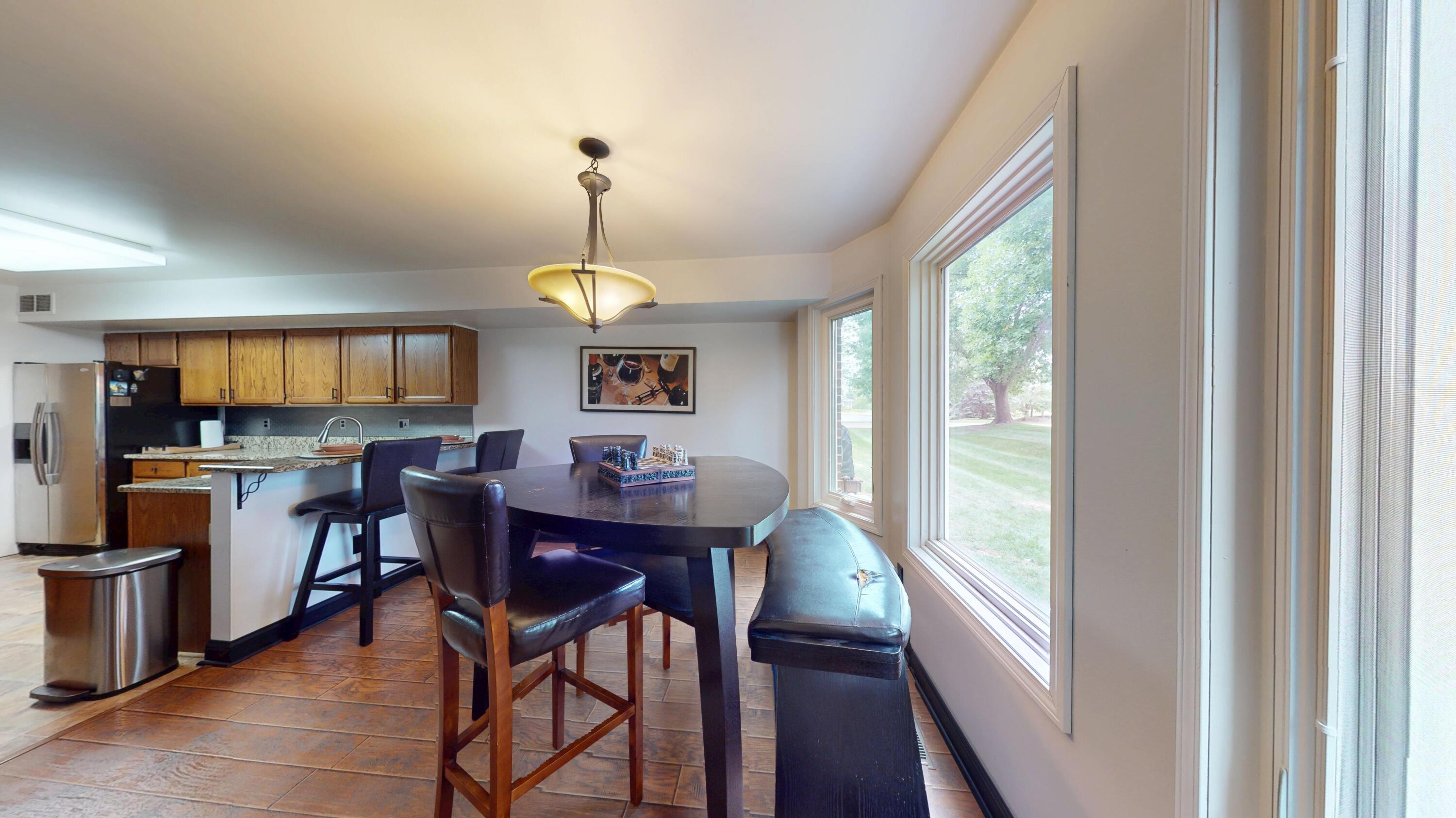 9344 Van Buren Street Crown Point, IN 46307 - Photo 16 of 37 a view of a dining room with furniture window and wooden floor