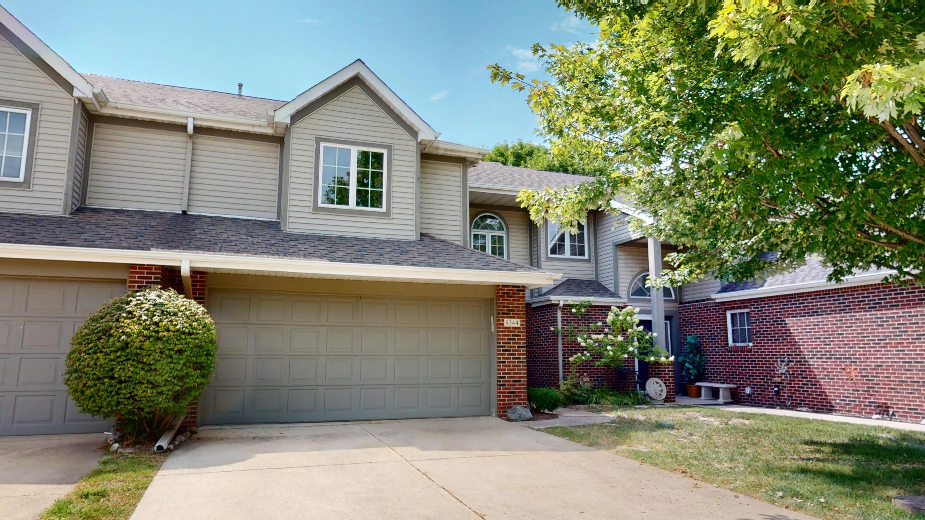 9344 Van Buren Street Crown Point, IN 46307 - Photo 2 of 37 a front view of a house with garden