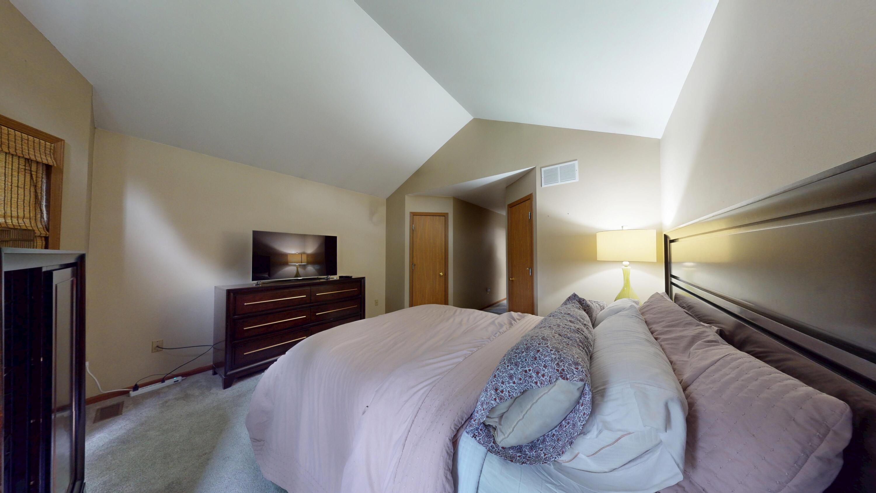 9344 Van Buren Street Crown Point, IN 46307 - Photo 26 of 37 a bedroom with a bed and a television