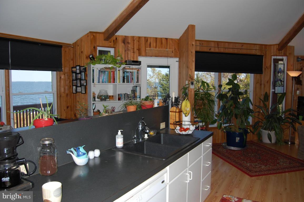 10770 Harrison Point Road Deal Island, MD 21821 - Photo 19 of 29 a kitchen with a sink dining table and chairs