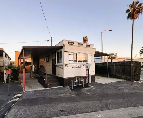 a view of a chairs and table in the backyard