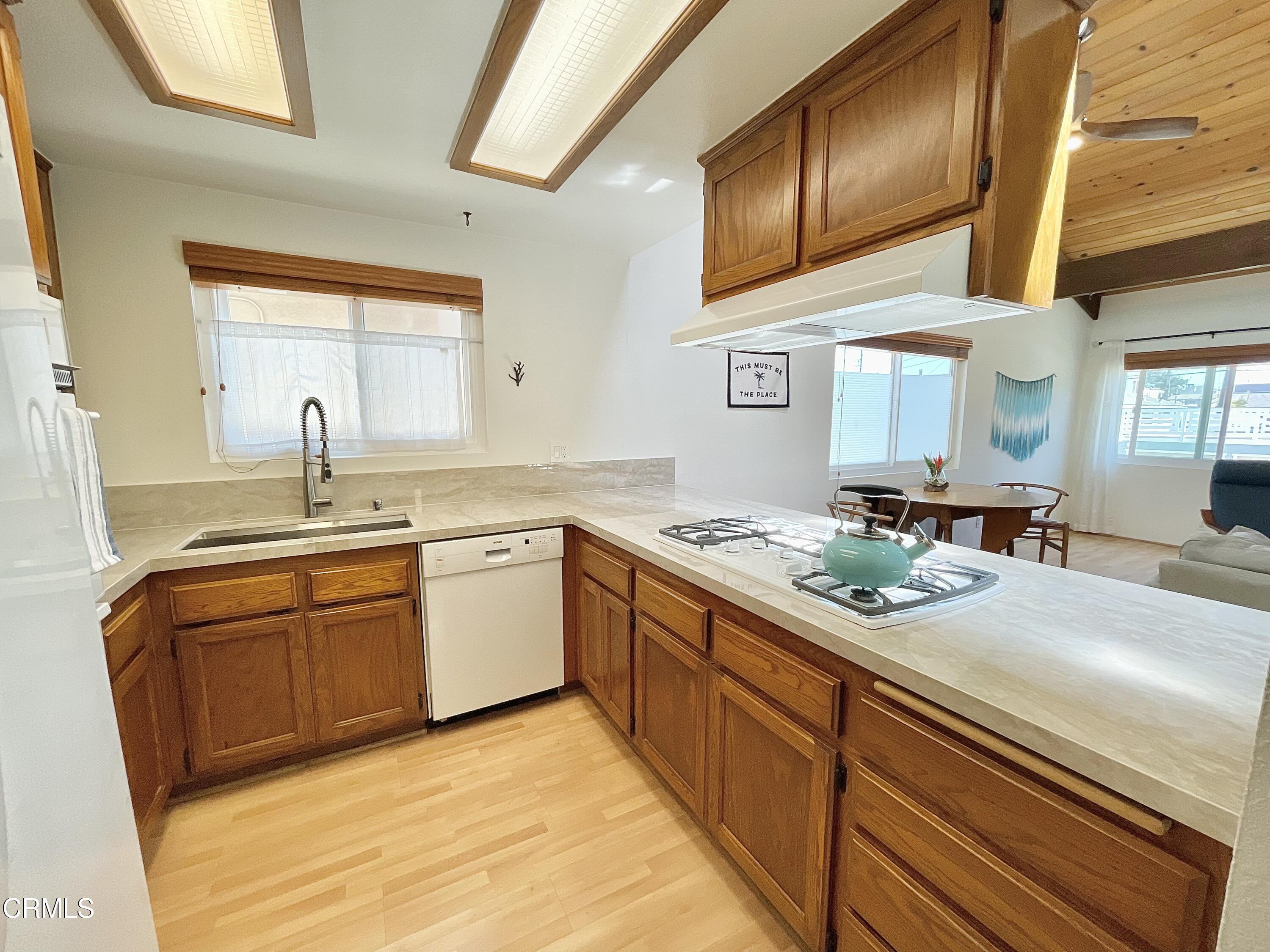 361 Rossmore Drive Oxnard, CA 93035 - Photo 12 of 26 a kitchen with stainless steel appliances granite countertop a sink stove and cabinets