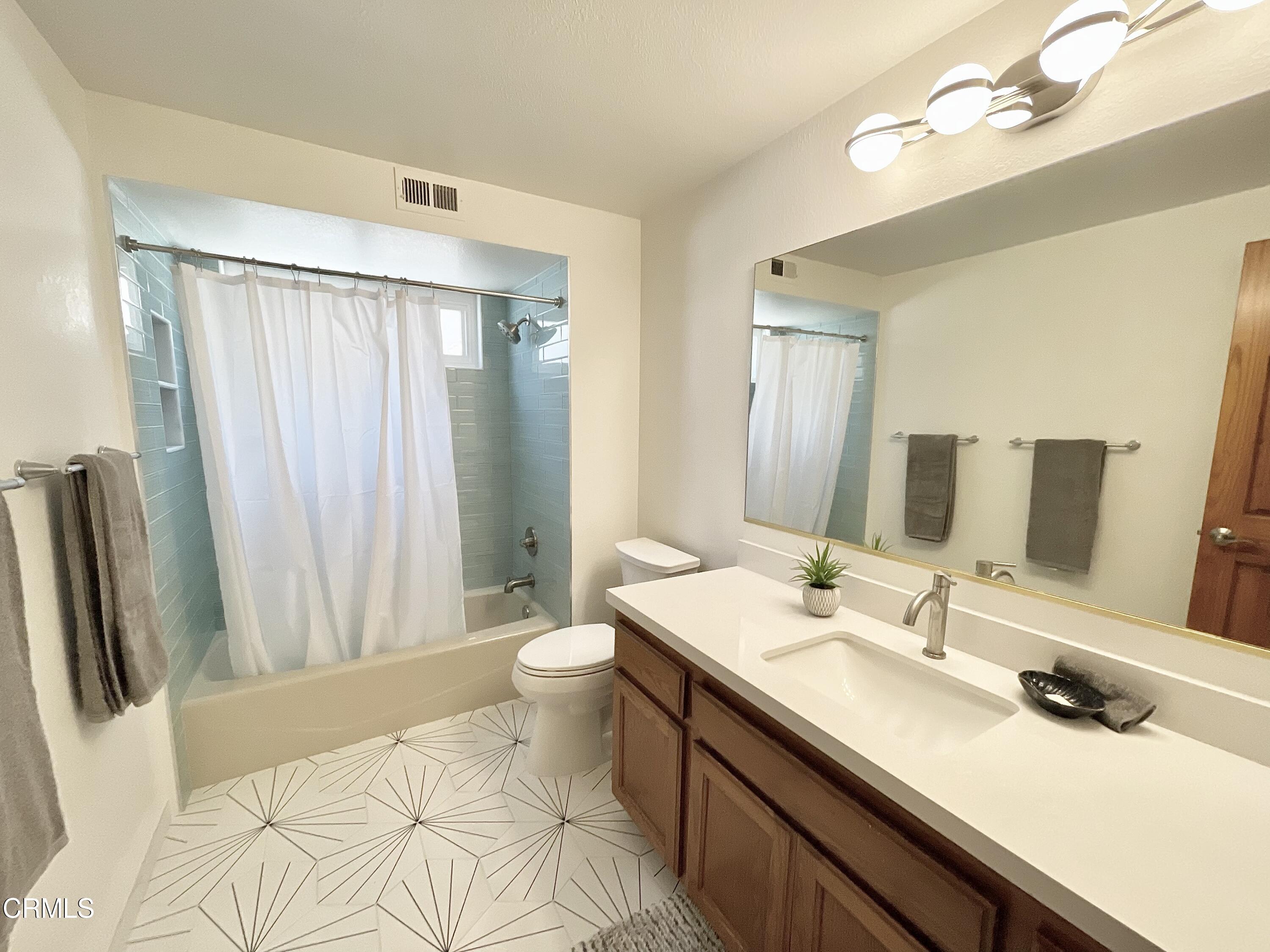 361 Rossmore Drive Oxnard, CA 93035 - Photo 17 of 26 a bathroom with a double vanity sink and mirror