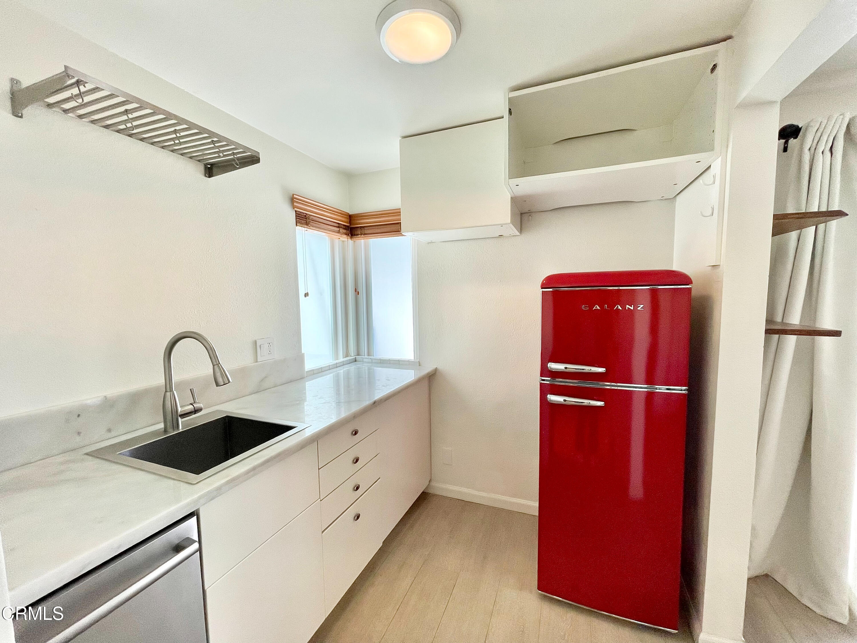 361 Rossmore Drive Oxnard, CA 93035 - Photo 21 of 26 a kitchen with a refrigerator and a sink