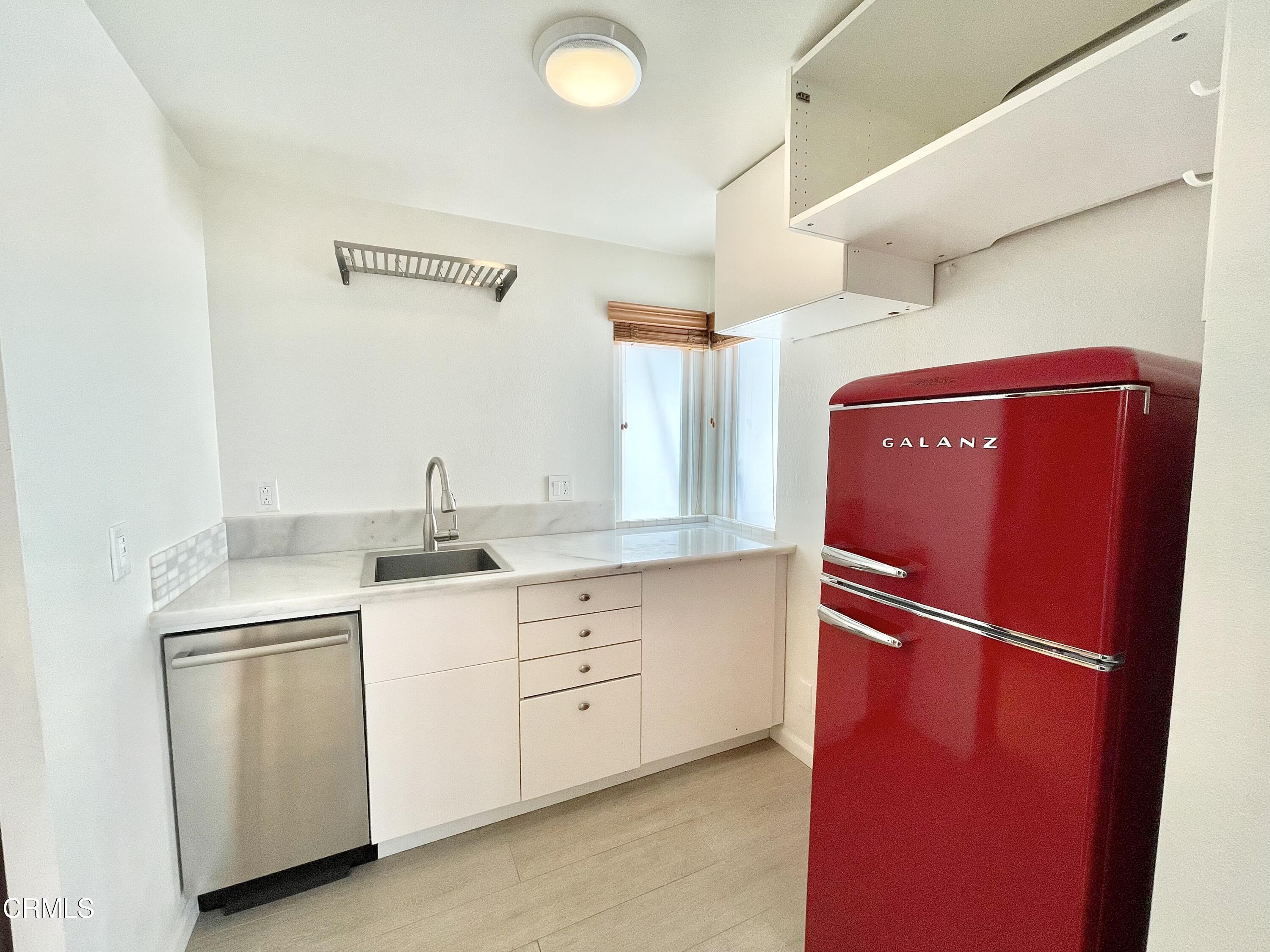 361 Rossmore Drive Oxnard, CA 93035 - Photo 22 of 26 a kitchen with white cabinets and sink