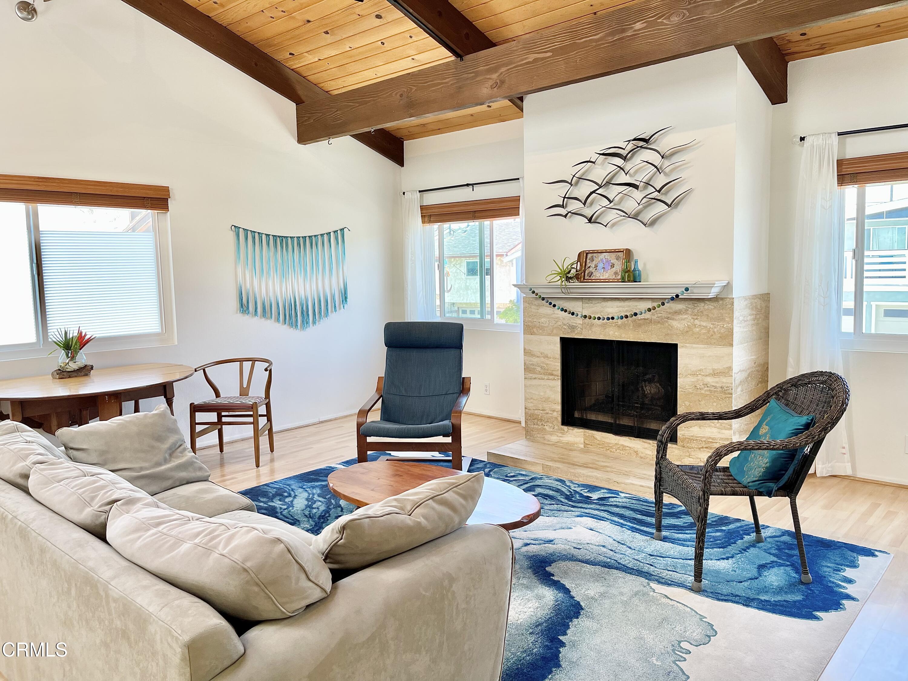 361 Rossmore Drive Oxnard, CA 93035 - Photo 7 of 26 a living room with furniture a fireplace and a large window