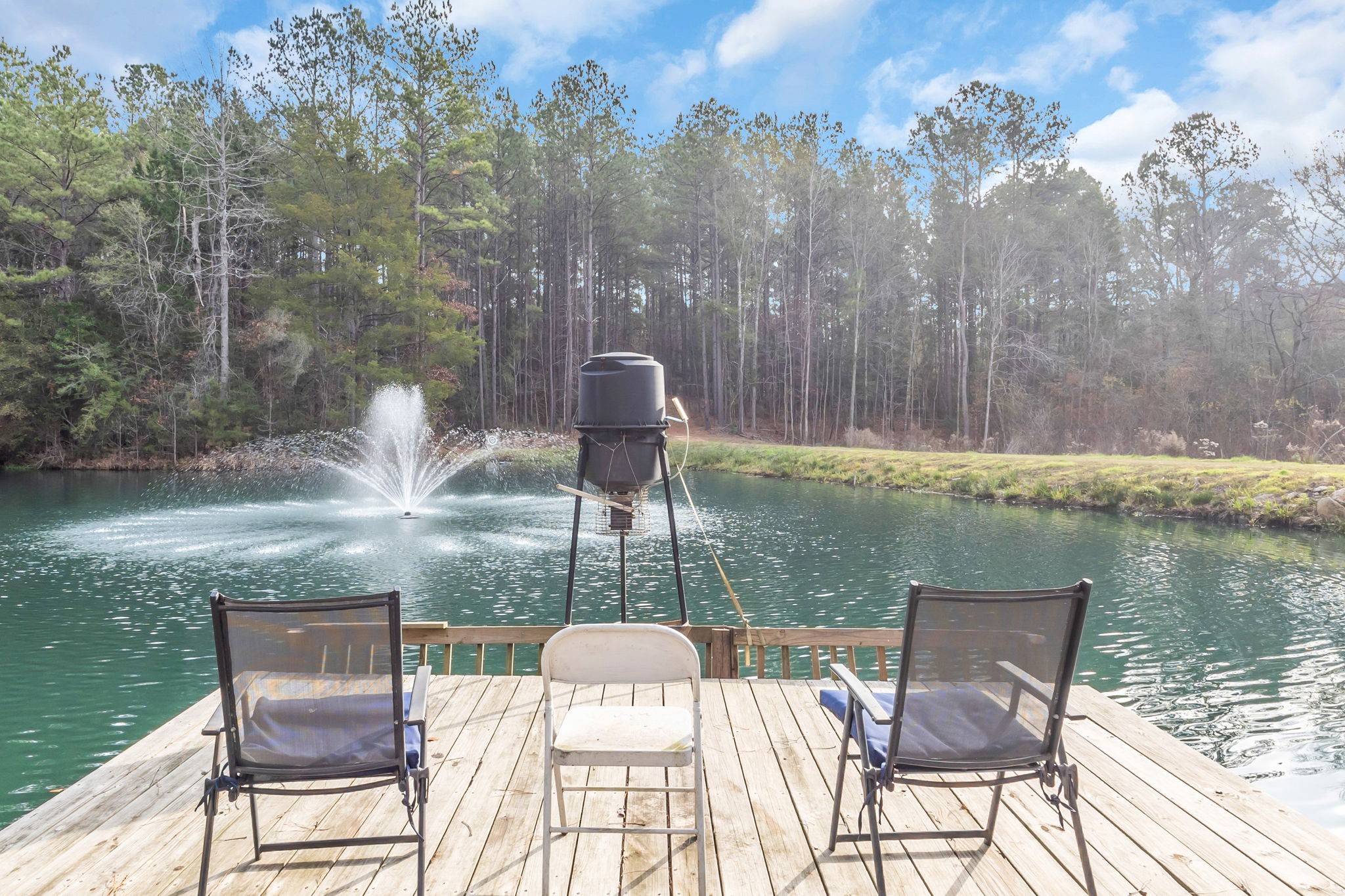 a view of a lake from balcony with furniture