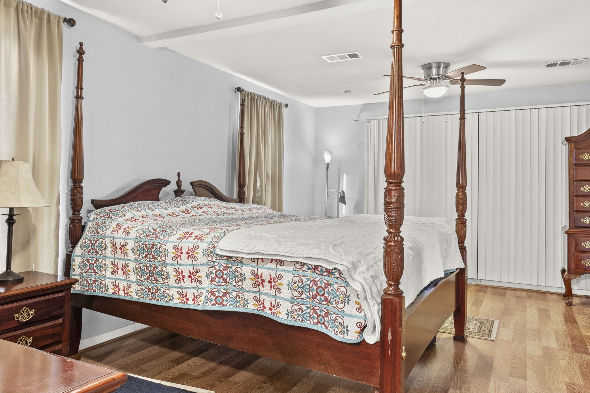 12498 Highway 69 Colmesneil, TX 75938 - Photo 18 of 50 a bedroom with a bed and a dresser with wooden floor