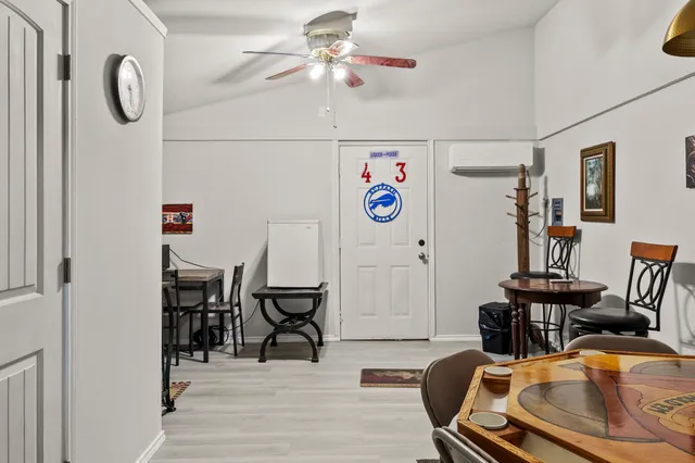 a view of a room with furniture and wooden floor