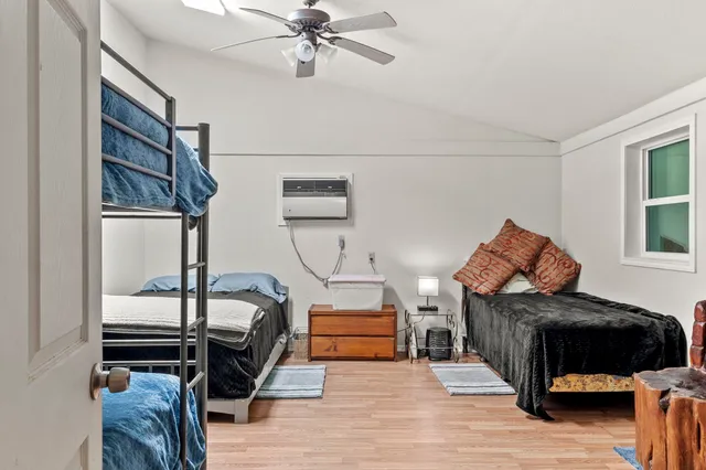 a bedroom with furniture and a mirror