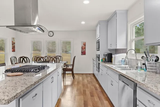 a kitchen with granite countertop lots of counter top space and windows