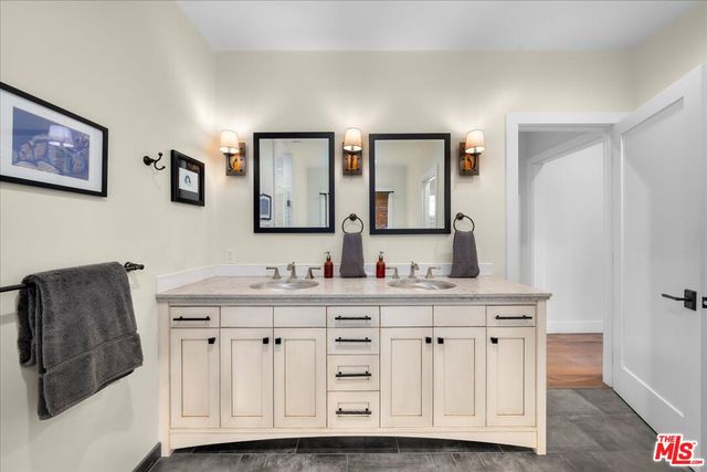 a spacious bathroom with a shower a sink and mirror