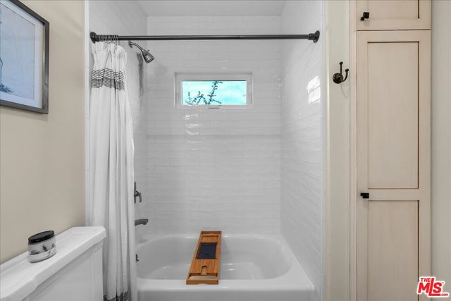 a bathroom with a toilet a sink and a window