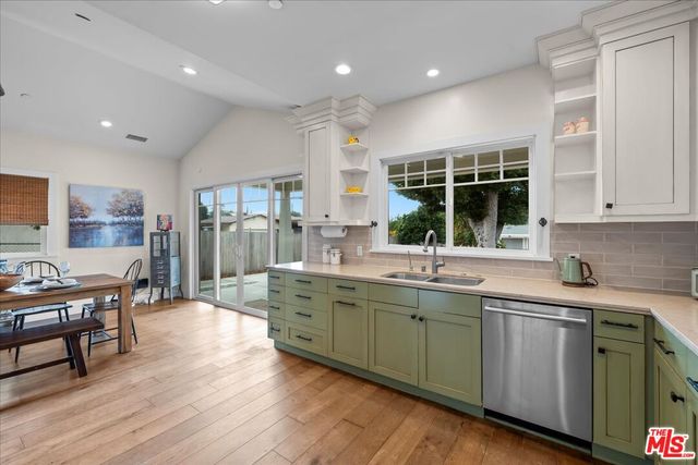 a kitchen with sink and cabinets