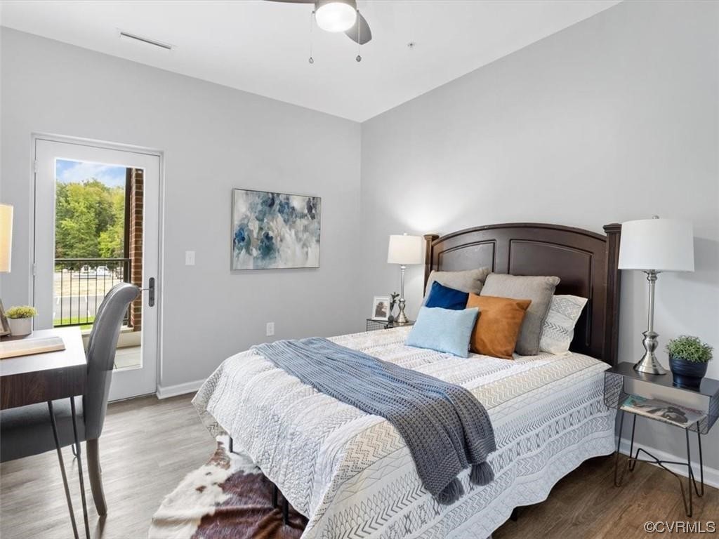 1504 Ewing Park Loop, Unit 206 Midlothian, VA 23113 - Photo 11 of 26 a bedroom with a bed and wooden floor