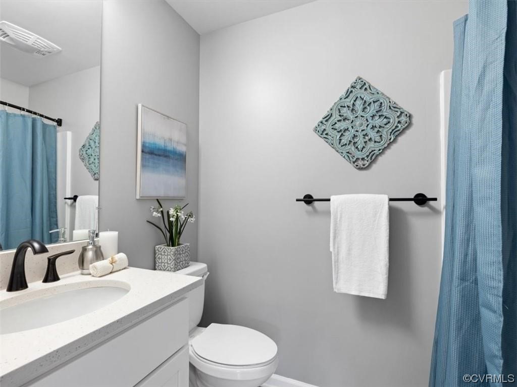 1504 Ewing Park Loop, Unit 206 Midlothian, VA 23113 - Photo 13 of 26 a bathroom with a toilet sink and shower