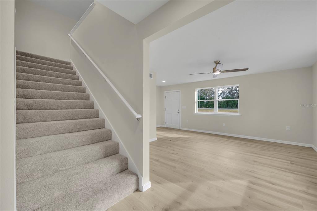 31201 Merry Road Tavares, FL 32778 - Photo 8 of 40 a view of an empty room with stairs