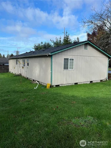 a view of backyard of house with green space