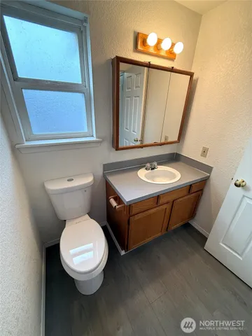a bathroom with a toilet sink and mirror