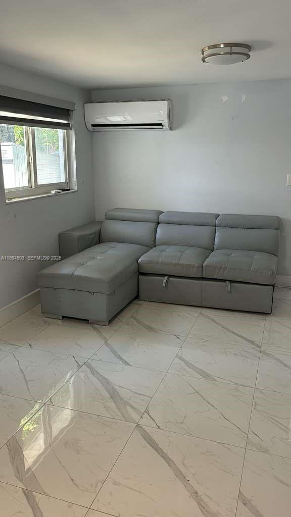 980 West 45th Place, Unit 2 Hialeah, FL 33012 - Photo 3 of 13 a living room with furniture and a window
