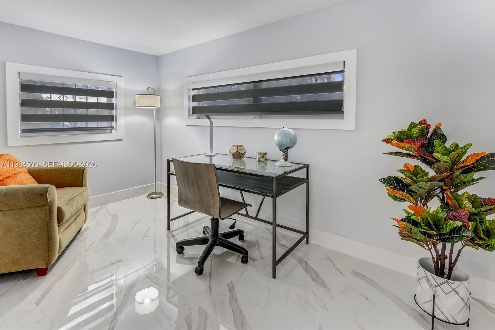 980 West 45th Place, Unit 2 Hialeah, FL 33012 - Photo 5 of 13 a work room with furniture and a potted plant
