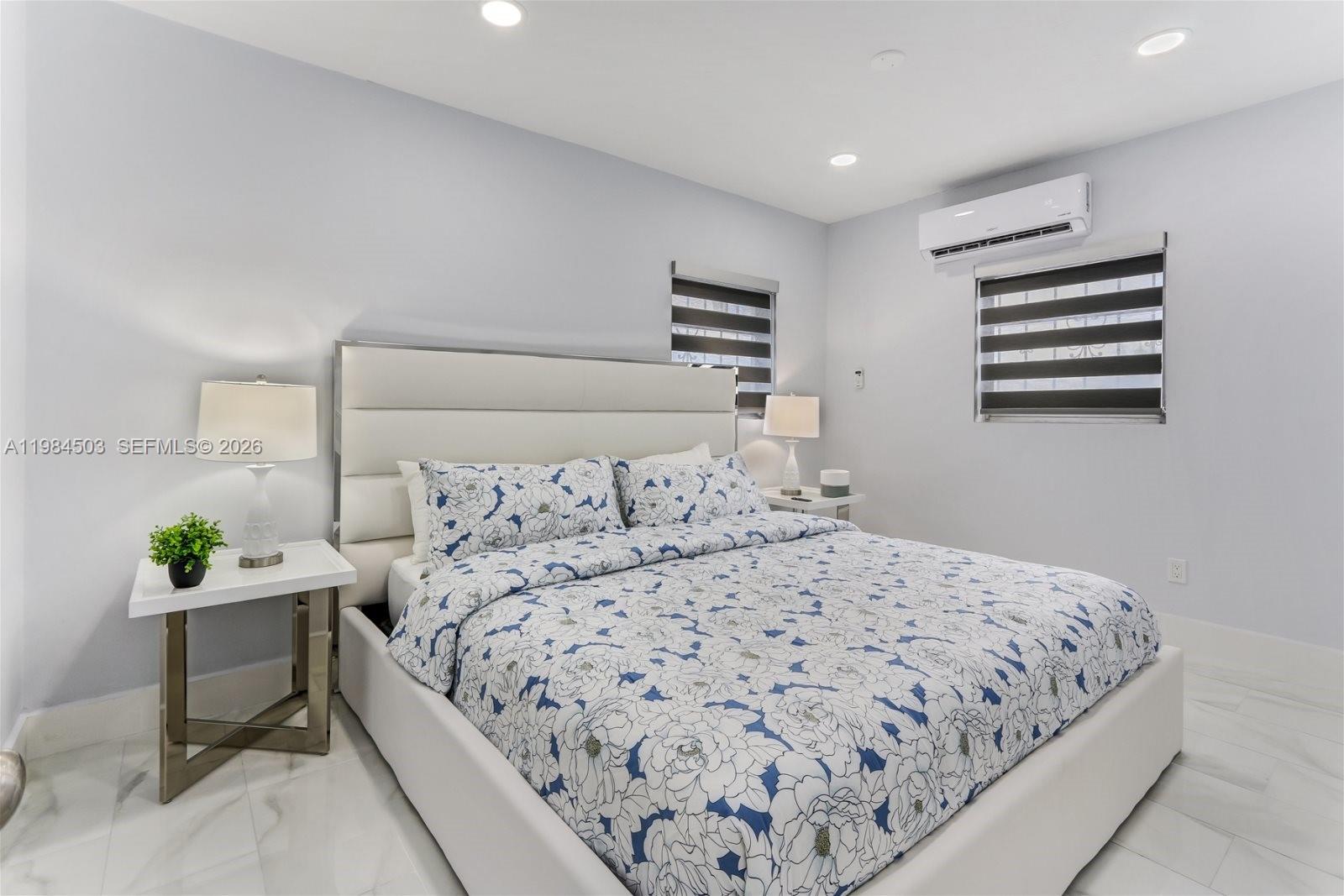 980 West 45th Place, Unit 2 Hialeah, FL 33012 - Photo 7 of 13 a bedroom with a bed and a window