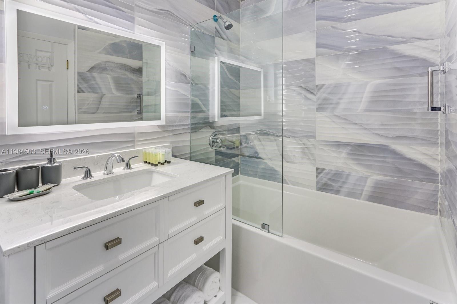 980 West 45th Place, Unit 2 Hialeah, FL 33012 - Photo 9 of 13 a bathroom with a tub sink and mirror