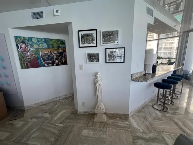 a view of a hallway with paintings on the wall