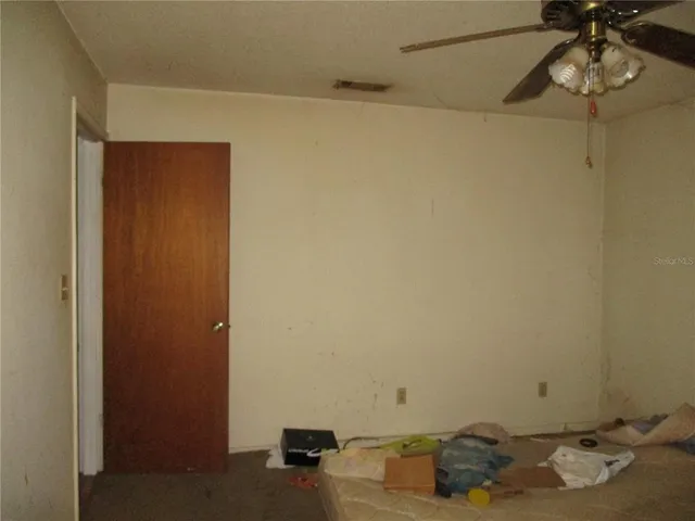 a room with a wooden floor and cabinets