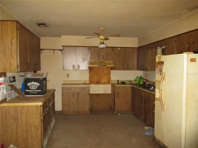 a kitchen with a refrigerator sink and stove