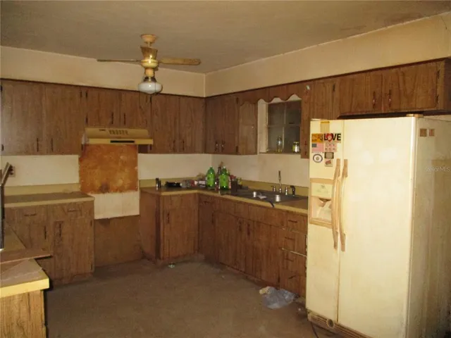 a kitchen with stainless steel appliances a refrigerator and a stove