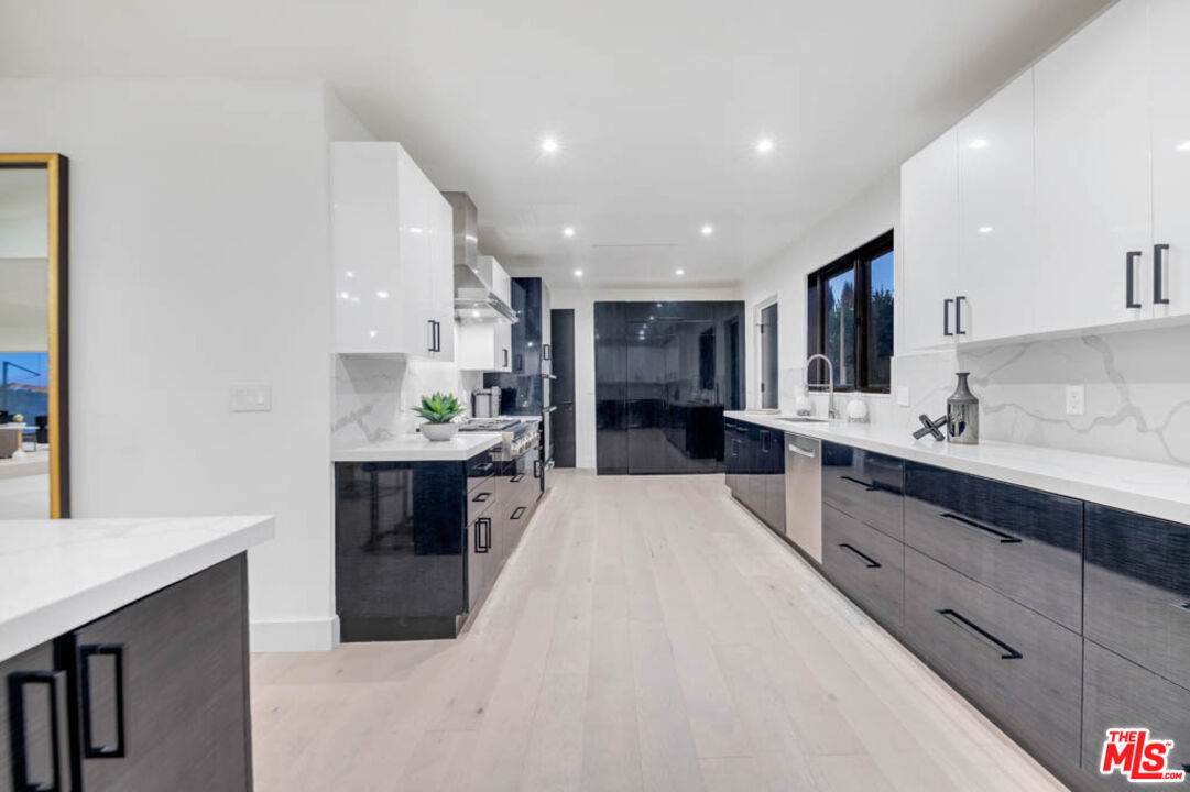2990 Lakeridge Drive Los Angeles, CA 90068 - Photo 17 of 53 a large kitchen with kitchen island a sink stainless steel appliances and cabinets