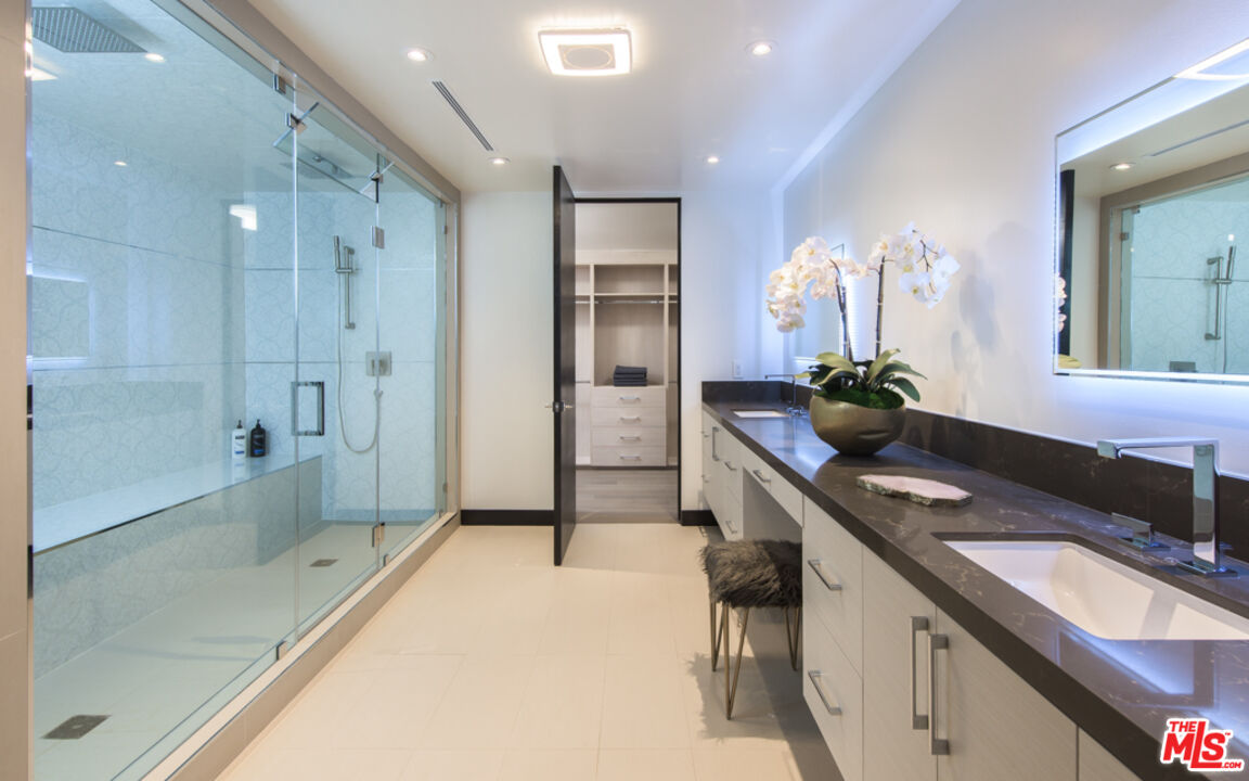 2990 Lakeridge Drive Los Angeles, CA 90068 - Photo 24 of 53 a spacious bathroom with a granite countertop sink mirror and shower