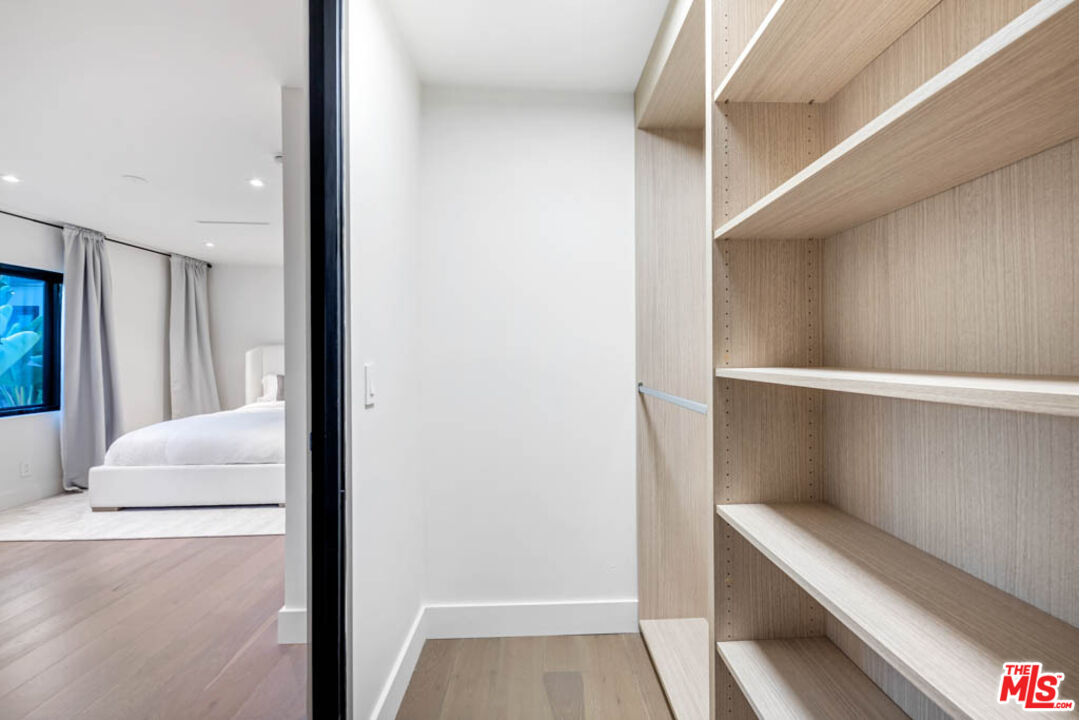 2990 Lakeridge Drive Los Angeles, CA 90068 - Photo 30 of 53 a hallway with white doors wooden floor and front door