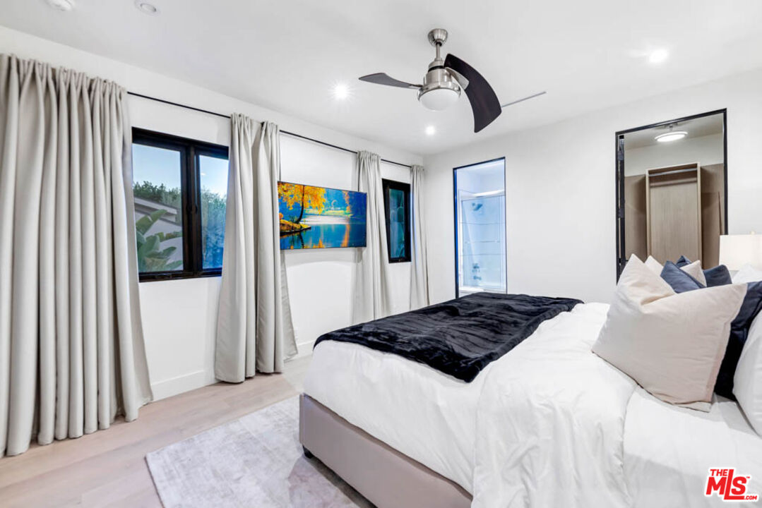 2990 Lakeridge Drive Los Angeles, CA 90068 - Photo 40 of 53 a bedroom with a bed and a walk in closet