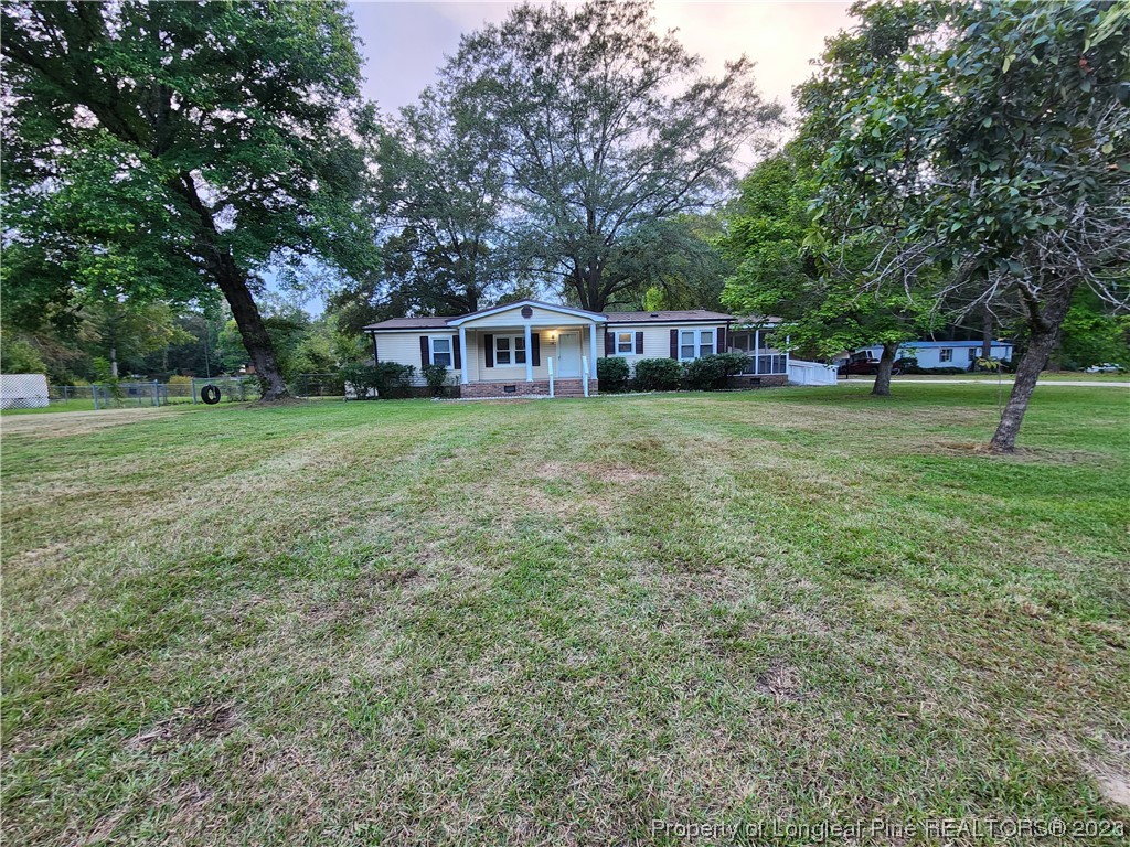 120 Winsor Drive Rockingham, NC 28379 - Photo 1 of 23 a front view of a house with a garden
