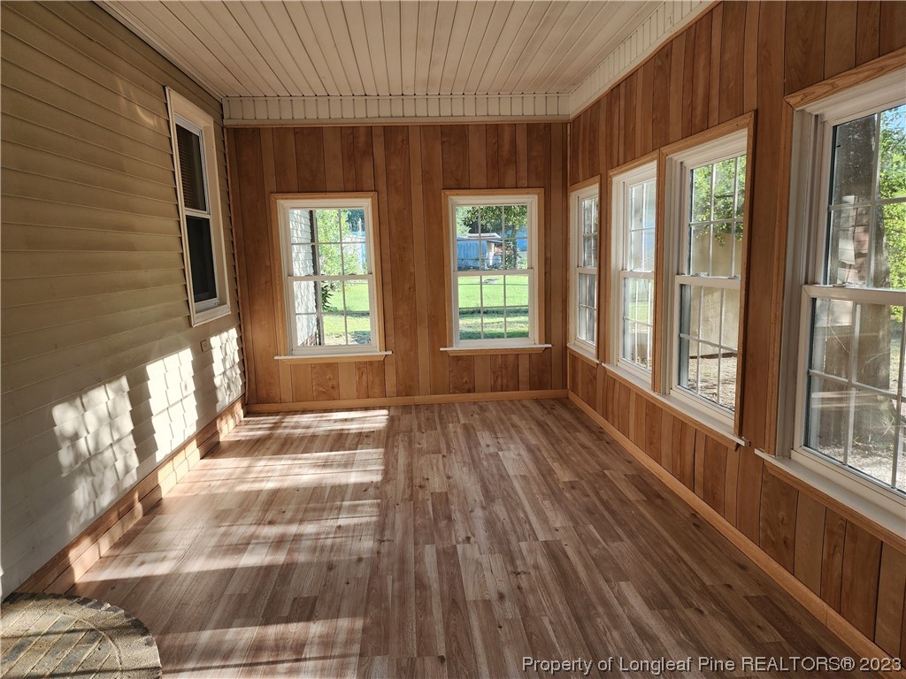 120 Winsor Drive Rockingham, NC 28379 - Photo 2 of 23 a view of an empty room with wooden floor and a window