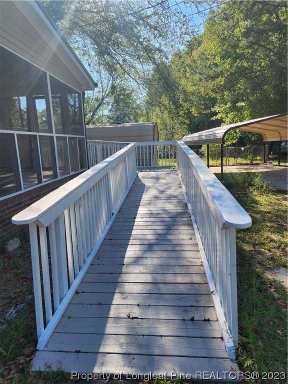 120 Winsor Drive Rockingham, NC 28379 - Photo 5 of 23 a balcony with wooden floor and outdoor seating