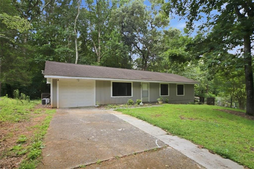 142 Deer Run Canton, GA 30114 - Photo 4 of 24 a front view of a house with a garden and trees