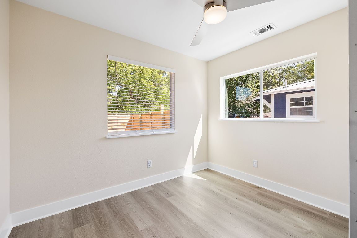 1171 Nickols Avenue, Unit 1 Austin, TX 78721 - Photo 18 of 22 Empty room featuring light wood-style flooring and a ceiling fan