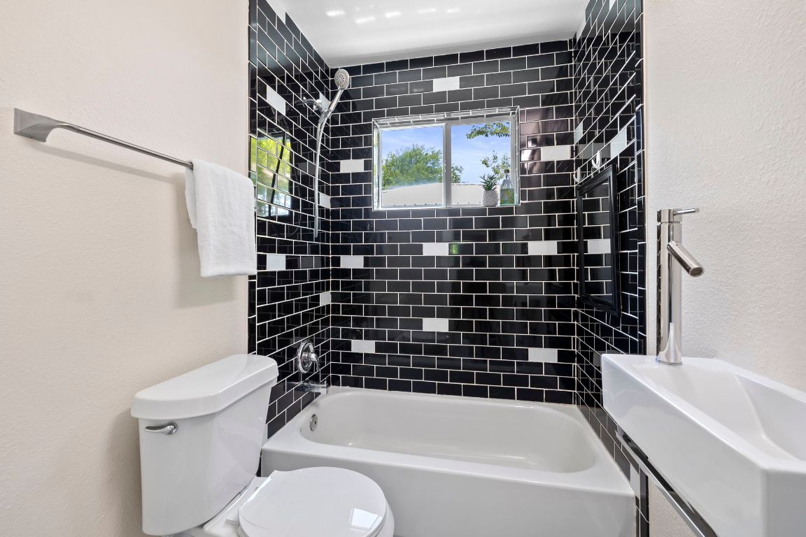 1171 Nickols Avenue, Unit 1 Austin, TX 78721 - Photo 19 of 22 Full bathroom featuring a textured wall and tub / shower combination
