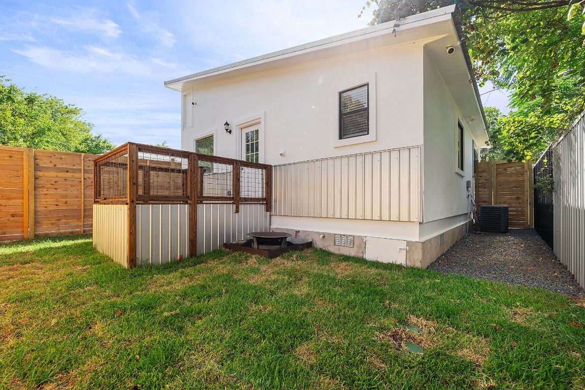 1171 Nickols Avenue, Unit 1 Austin, TX 78721 - Photo 22 of 22 Rear view of house featuring crawl space, a fenced backyard, and a wooden deck