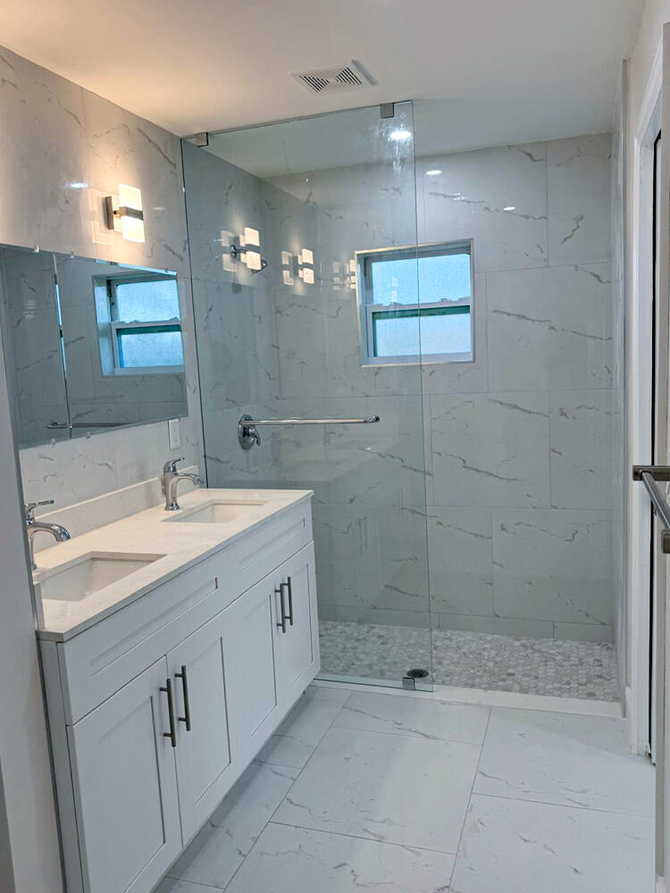 6465 Alexander Road West Palm Beach, FL 33413 - Photo 12 of 20 a bathroom with a shower sink and mirror