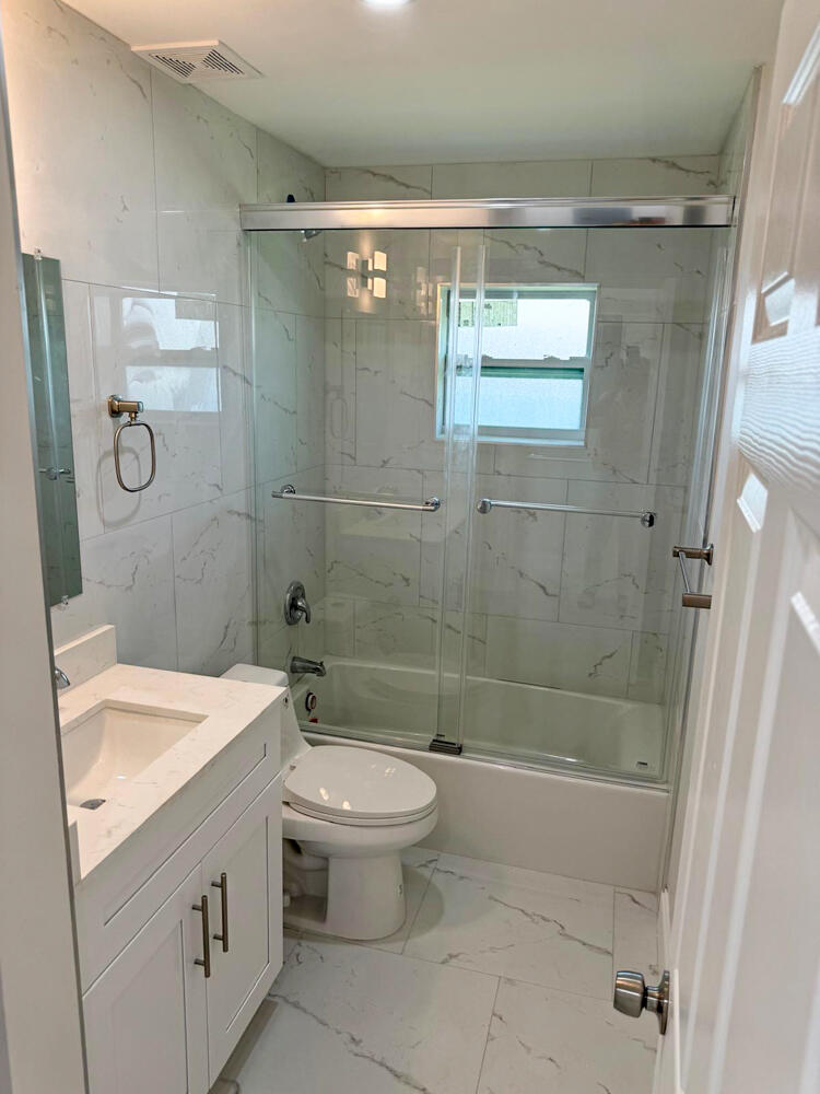 6465 Alexander Road West Palm Beach, FL 33413 - Photo 16 of 20 a bathroom with a sink a toilet and shower