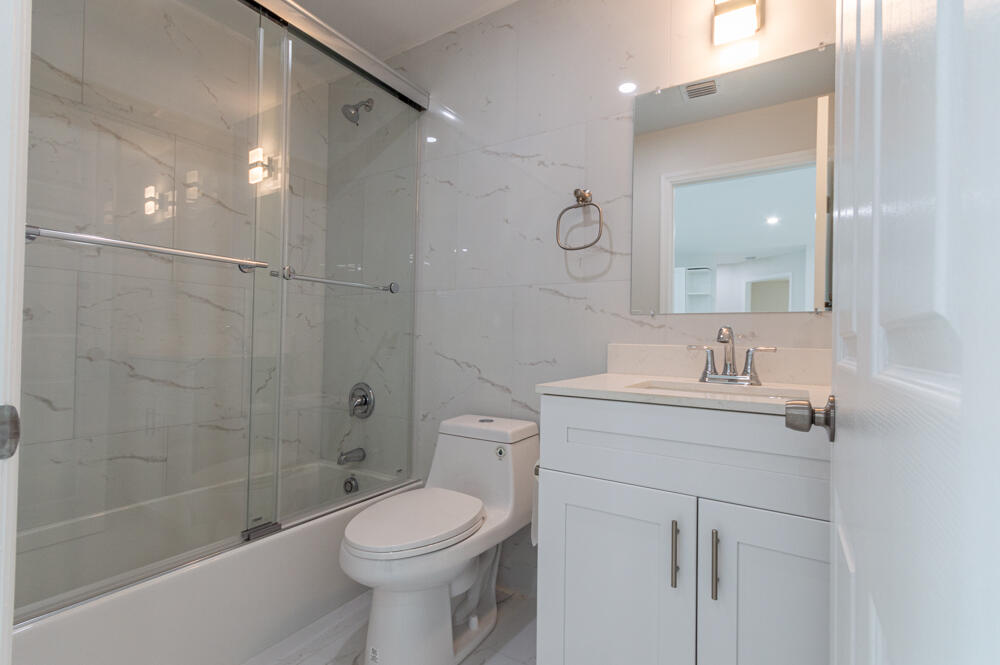 6465 Alexander Road West Palm Beach, FL 33413 - Photo 17 of 20 a bathroom with a sink a toilet and shower