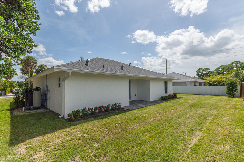 6465 Alexander Road West Palm Beach, FL 33413 - Photo 19 of 20 a view of a house with a yard and garage