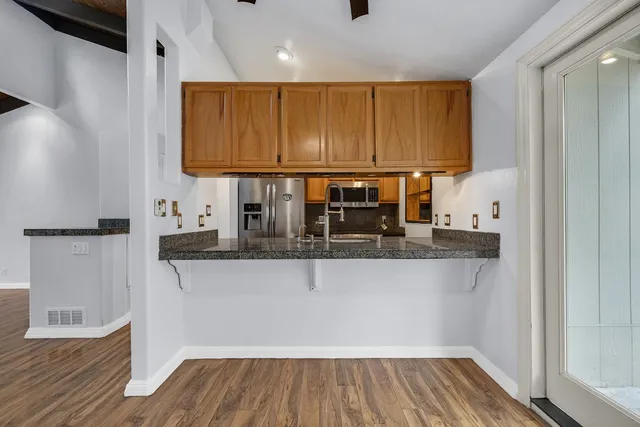 a living room with furniture potted plant and a flat screen tv