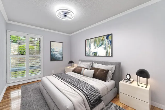 a bedroom with a bed and a window