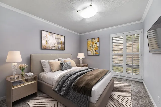 a view of a hallway with wooden floor and a bathroom